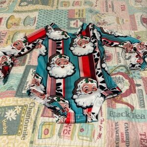 Santa, Santa and Santa onesie with bell ruffle on sleeve.